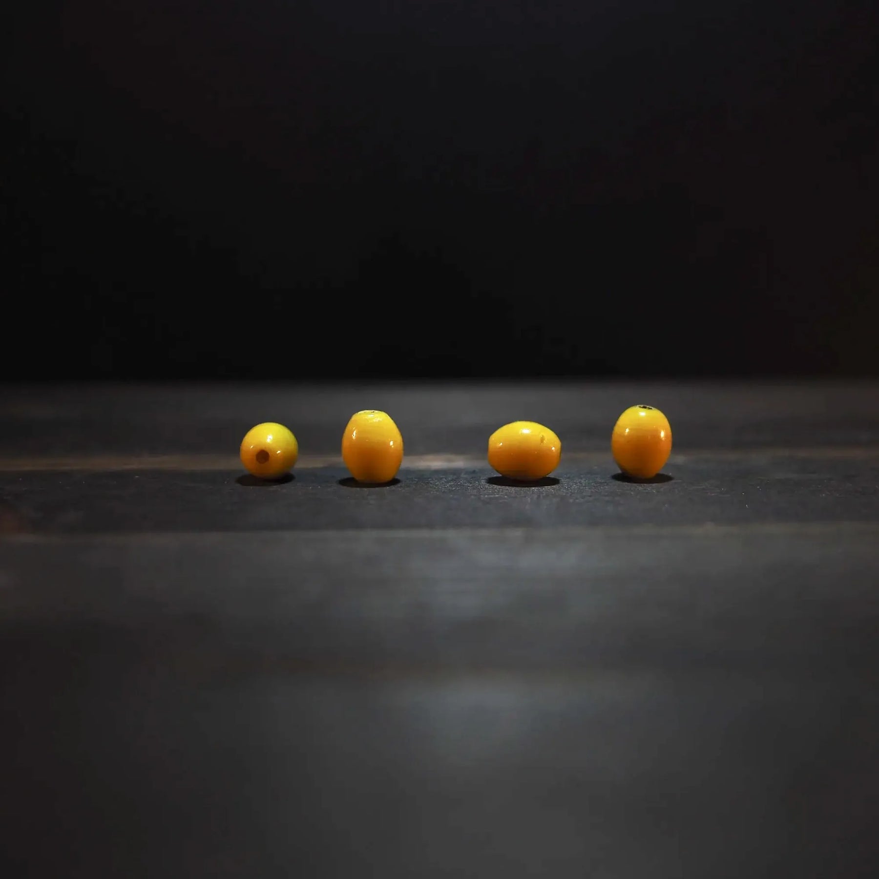 Oval yellow glass bead