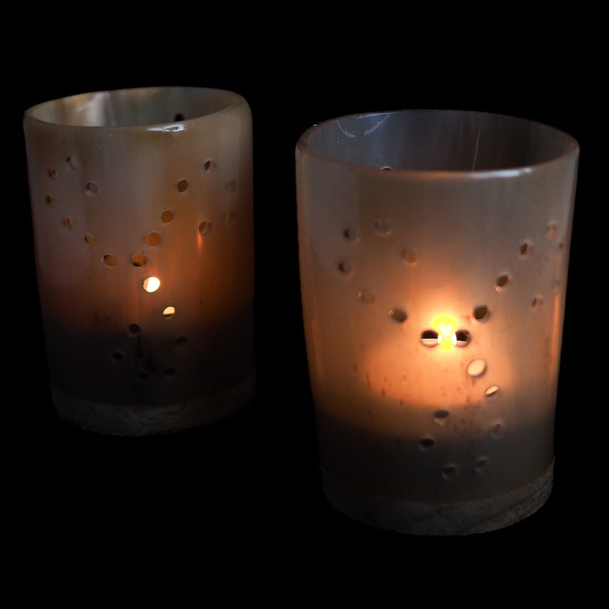 Horn candle lanterns – two lanterns with lit tealights and hole pattern, dark background