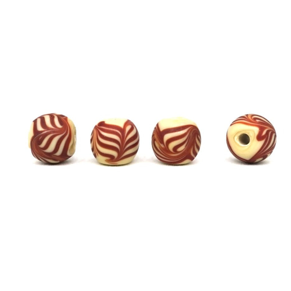 Beige glass bead with brown decoration, matt