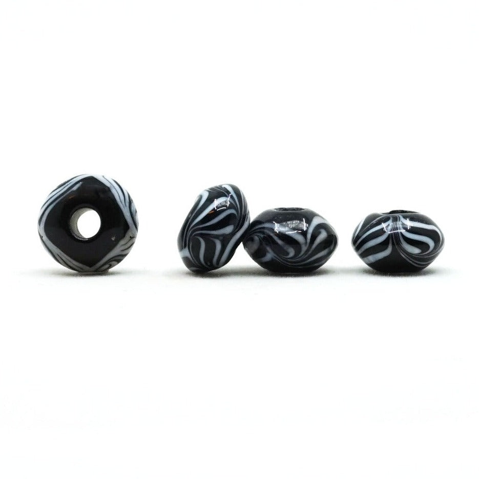 Black glass bead with white decoration