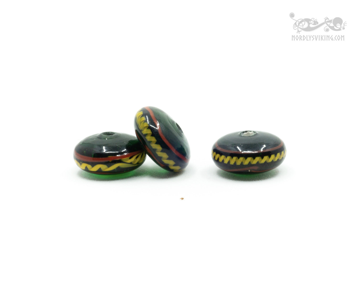 Green shiny glass bead with decoration