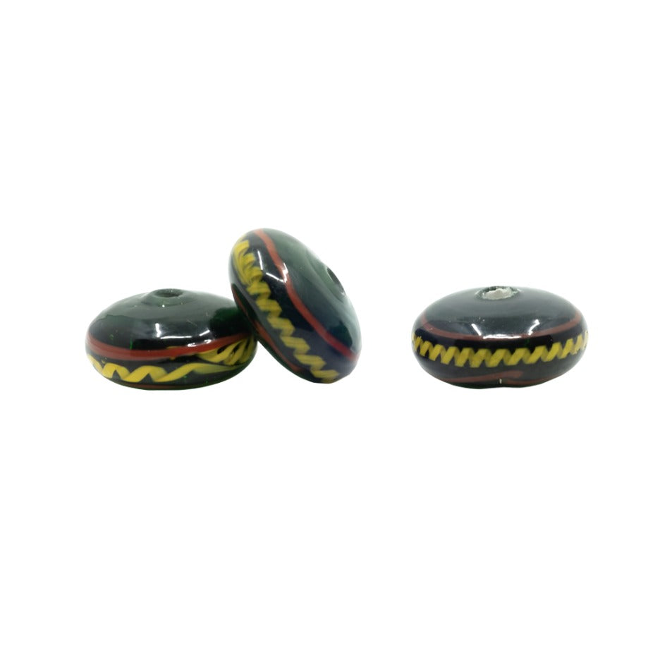 Green shiny glass bead with decoration