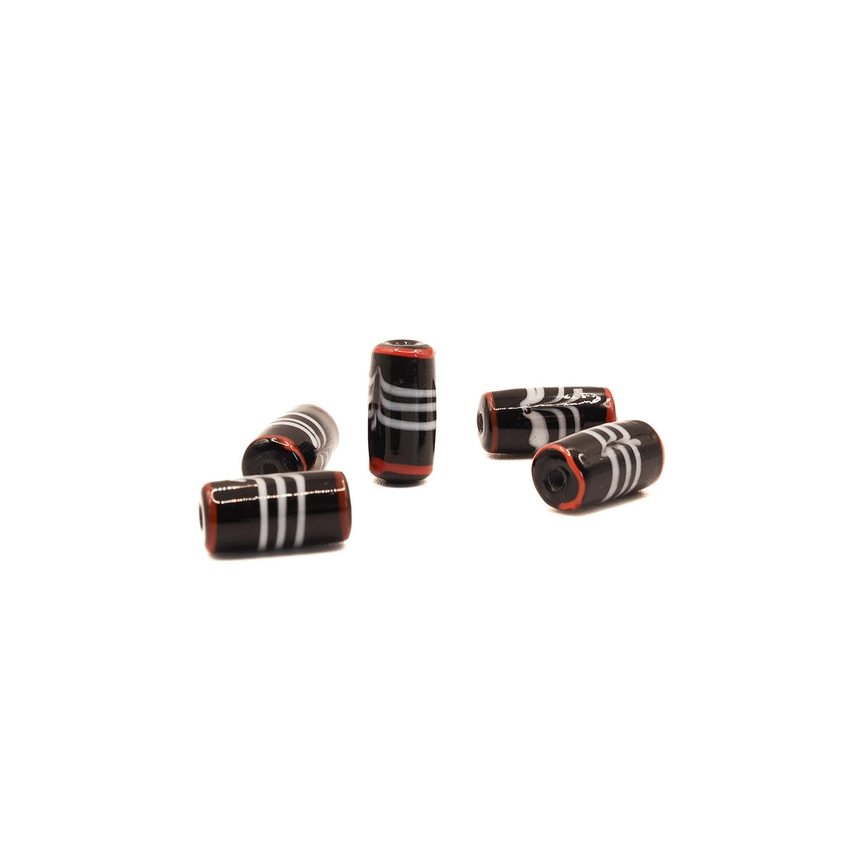 five black glass beads with white and red decor