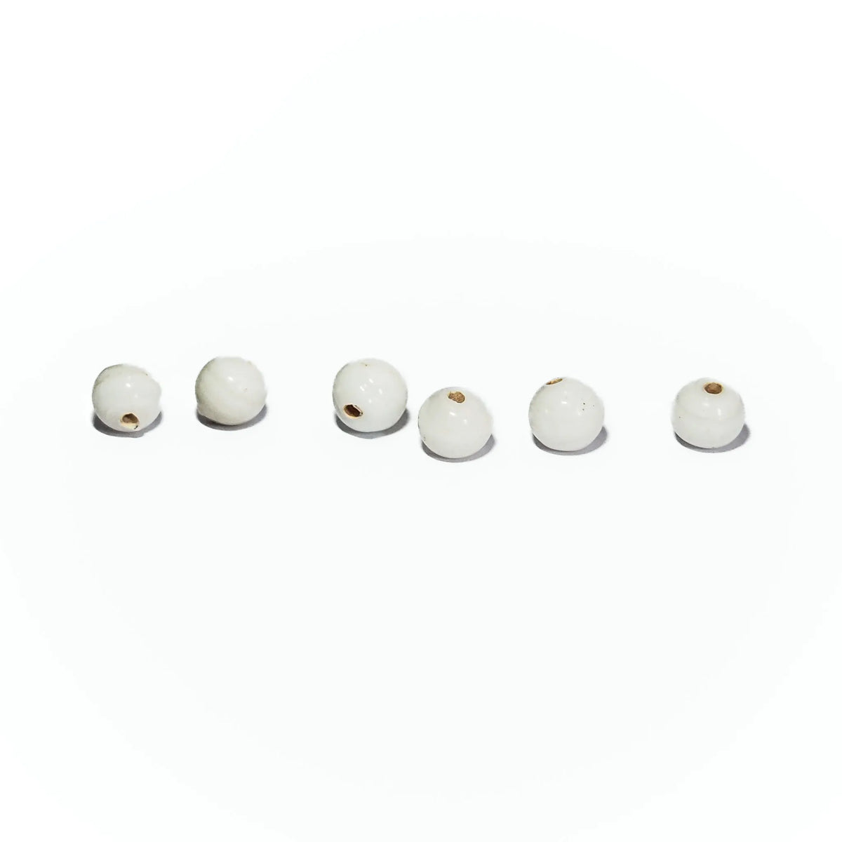 White round glass bead – six beads on a light background