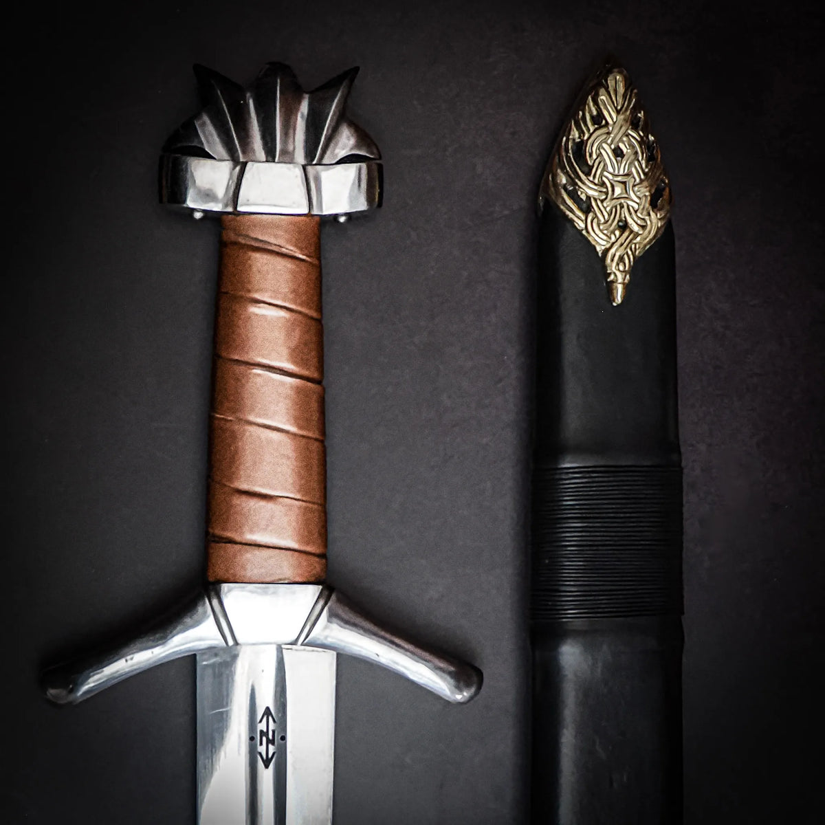 Kungarnas Dal Viking sword – hilt and the scabbard's gold fitting in close-up side by side