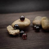 Muted purple glass bead – four beads in varying dark purple-red shades