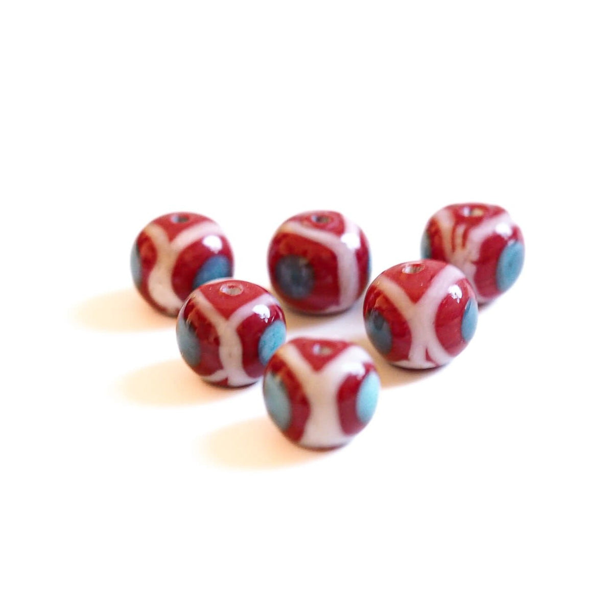 Red glass bead with decoration, glossy