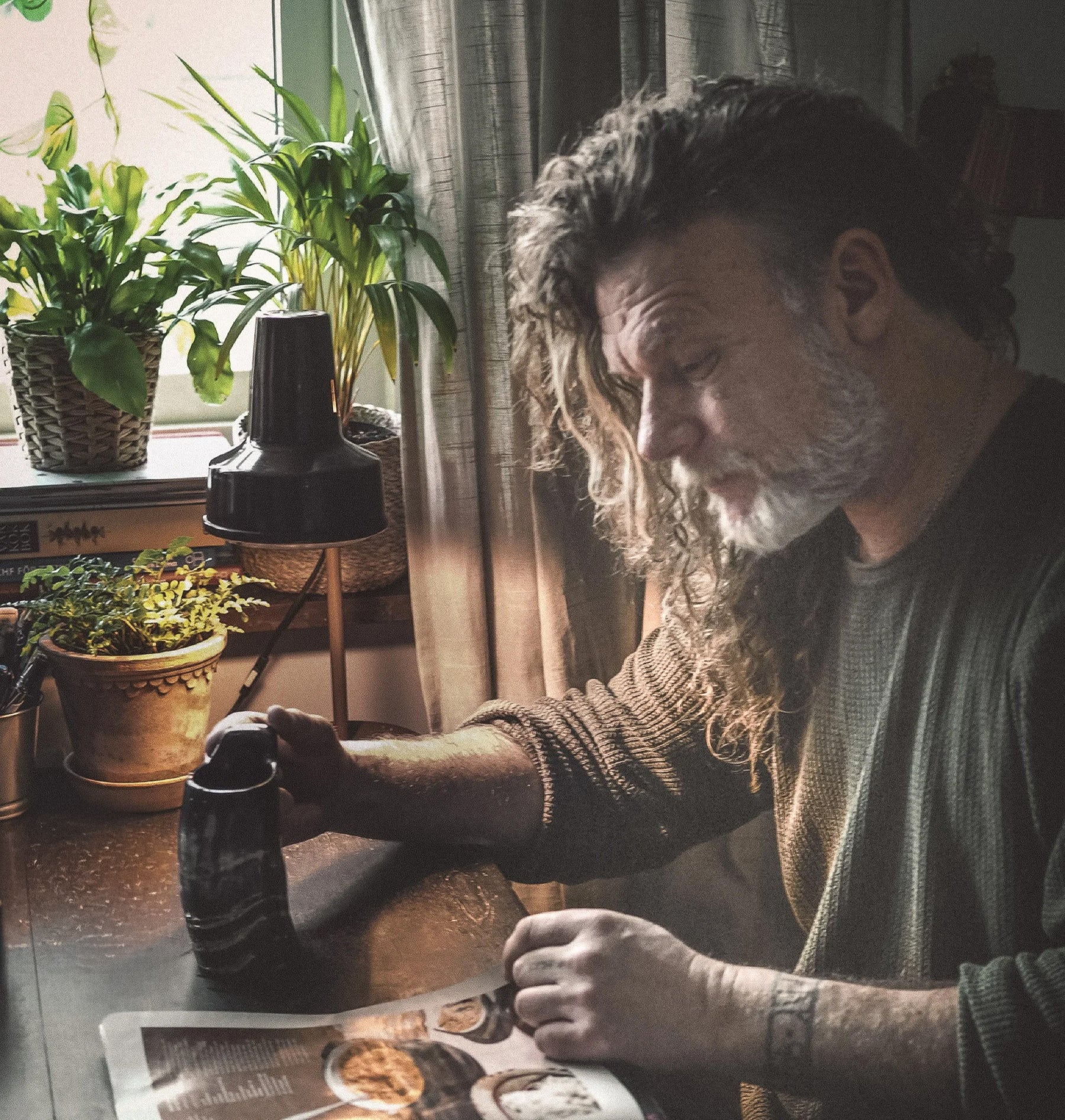 Stor kaffemugg i horn – mörk marmorerad mugg på bord bredvid man som läser tidning