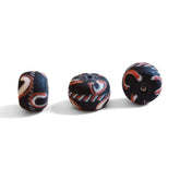 Large black glass bead with decoration, matt