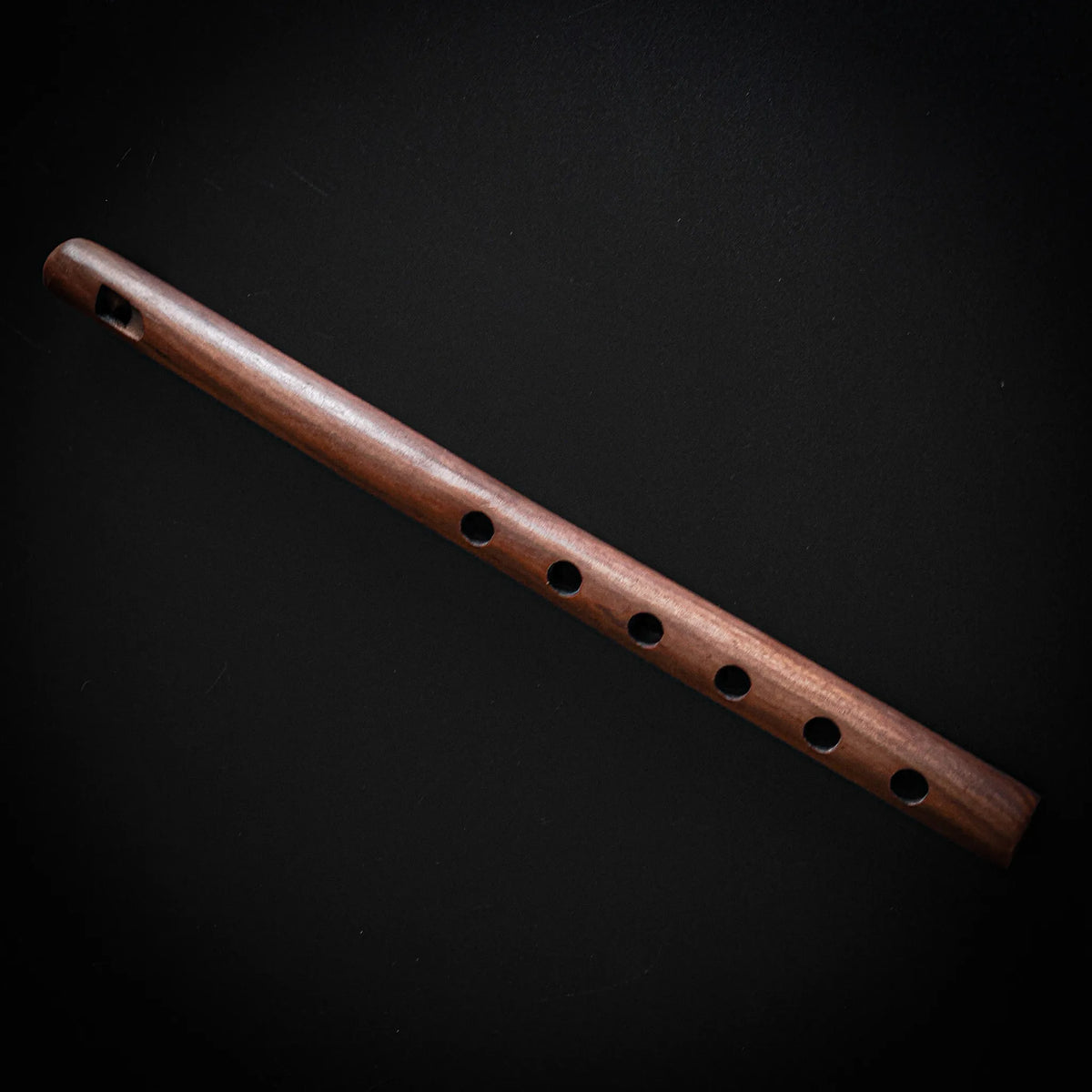 Wooden flute toy with multiple finger holes, traditional folk instrument design