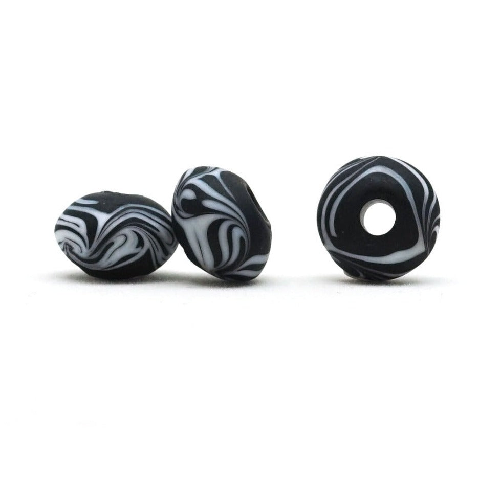 Black glass bead, with white decoration