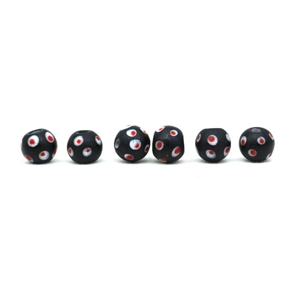 Black glass bead with pink eyes