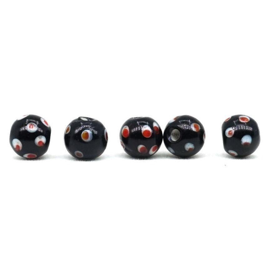 Black glass bead with pink eyes, Halltorp, shiny