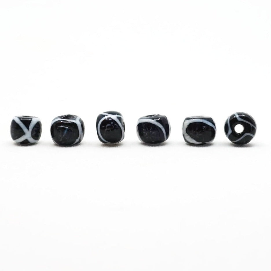 Black glass bead with white decoration