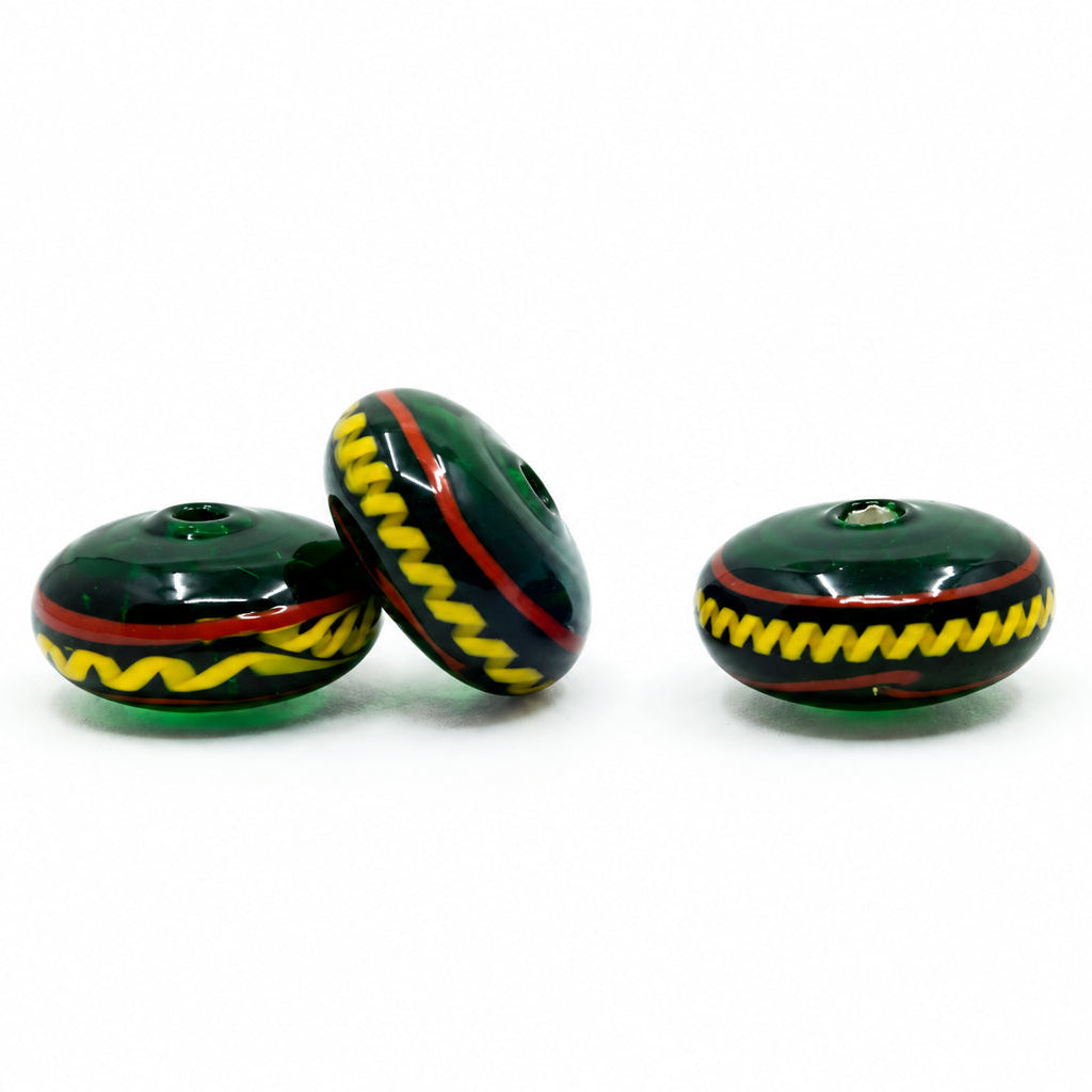Green glossy glass bead with decor, Bodarp – three disc-shaped beads with a yellow zigzag pattern