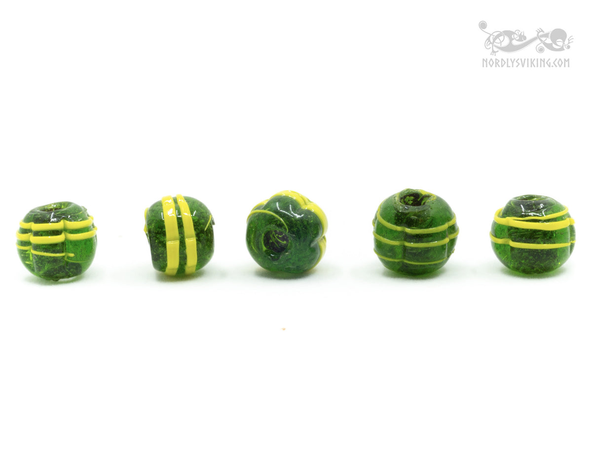 Dark green melon-shaped glass bead with yellow decoration