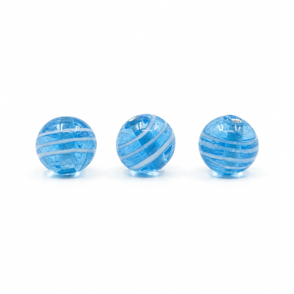 Light blue glass bead with white stripes – three beads, the streaked pattern clearly visible